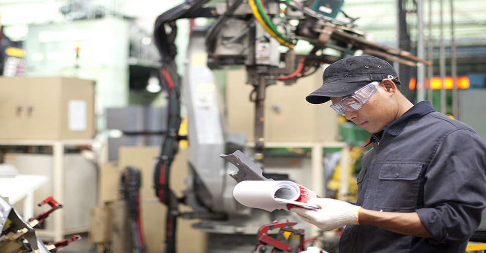 Foreman in a factory checking quality of work